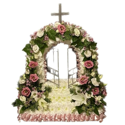 Heavenly Gates Tribute - A graceful gates of heaven funeral tribute in soft pink and white tones, finished with a cross and delicate greenery.