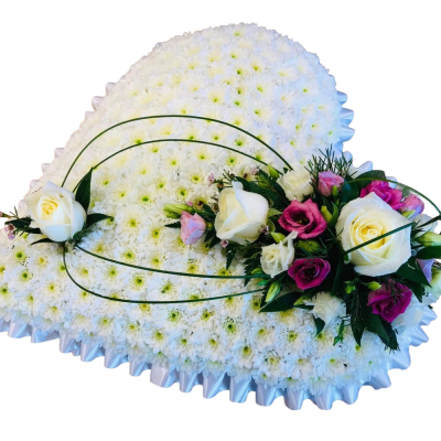 Forever in Our Hearts - An elegant heart-shaped funeral tribute in classic white, finished with a delicate arrangement of pink and white flowers.