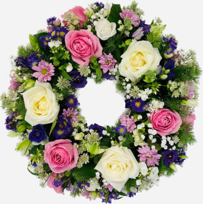 Pink & Violet Wreath - A beautiful open funeral wreath in soft pink, white and purple tones, finished with fresh greenery.