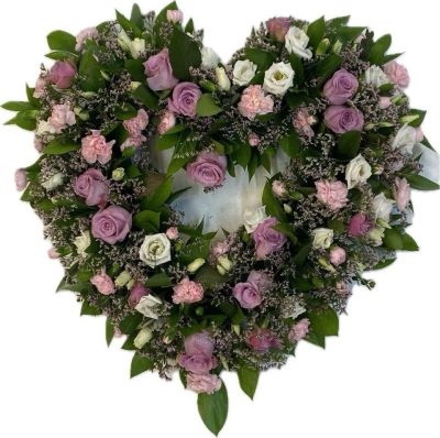 Soft Pink & Lilac Heart - A delicate open heart funeral tribute in soft pink, lilac and white tones, complemented by fresh green foliage.