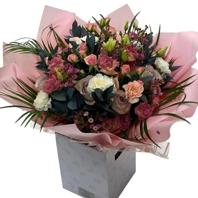 Pink Whisper - A graceful hand-tied bouquet in soft pink, peach, white and muted mauve tones, complemented by rich greenery.