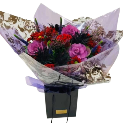 Midnight Bloom - A dramatic hand-tied bouquet combining vivid pink, rich red and deep purple tones with dark textured greenery.