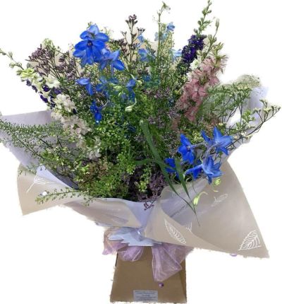 Wild Blue - A naturally styled hand-tied bouquet combining vivid blue, soft pink, white and purple tones with delicate greenery.