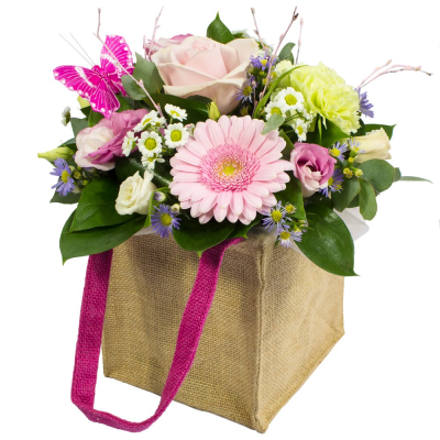 Hugs and Kisses - Petite Gift Bag arrangement in a hessian bag. Mix of flowers in pale pink, white and green. Made by an experienced Birmingham florist, this Hugs and Kisses offers a personal alternative to a generic postal flower delivery. Complementary flowers and foliage are selected to give the arrangement attractive movement, depth and a well-finished presentation. Because fresh flowers naturally change through the year, particular varieties may be substituted with comparable choices that retain the inte...
