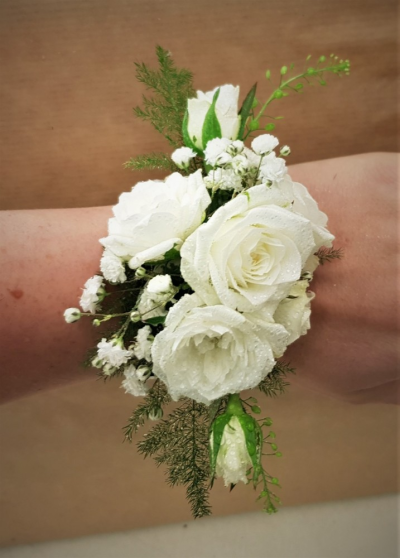 Wrist corsage - White rose wrist corsage Handcrafted by our Birmingham florists, this Wrist corsage brings considered colour, texture and natural detail to a wedding day. Each piece is arranged to feel natural and polished, with textures selected to complement the chosen wedding atmosphere. Fresh materials are selected according to quality and supply, with thoughtful alternatives used when necessary to maintain the pictured character. Couples can contact the shop to discuss dates, preferred colours, venue i...