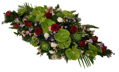 Contemporary Casket spray - This distinctive casket spray brings together the soft green shades green anthuriums and hydrangeas, with delicate pink ande lilac carnations, freesias and september flowers.and vivid red roses through the middle The spray is finished with aspidistra, aralia leaves and palm leaves. Please note: The image relates to the large variant. Approximate product dimensions: Standard width: 45cm, Length: 92cm. Large width: 50cm, Length: 120cm. Extra large width: 60cm, Length: 150cm Handcrafted by Butt...