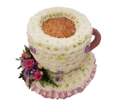 Teacup and Saucer - This three dimensional floral tribute is created in the shape of a teacup and saucer using fresh flowers. White double spray chrysanthemums, white spray roses and purple lilac statice give the cup shape and colour, and the display is mounted on a base with a small rose spray in pinks and lilacs. Designed and made by Buttercups & Daisies Florist Birmingham, this Teacup and Saucer offers families a personal way to express remembrance through flowers. The design is assembled patiently, with sui...