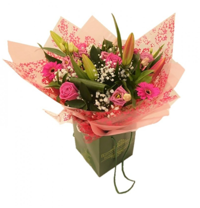 Pink Radiance Hand Tied - Our most popular Hand tied bouquet featuring all your favourites. Pink roses, pink lilies, cerise germini and pink lisianthus are complemented by foliage and gypsophila. Our experienced Birmingham florists create this Pink Radiance Hand Tied with a respectful finish suitable for a funeral, commemoration or celebration of life. Every section is constructed with attention to symmetry, visual depth and neat edging, helping the tribute look considered from different viewpoints. Fresh materials a...