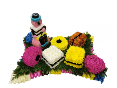 Bertie Bassett Allsorts Floral Tribute - Bertie Bassett Allsorts Floral Tribute created by our skilled florists at Buttercups & Daisies florists Birmingham Our experienced Birmingham florists create this Bertie Bassett Allsorts Floral Tribute with a respectful finish suitable for a funeral, commemoration or celebration of life. Every section is constructed with attention to symmetry, visual depth and neat edging, helping the tribute look considered from different viewpoints. Fresh materials are selected according to quality and sup...