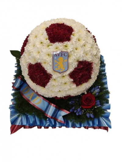 Football Tribute 3D (villa) - This tribute is the perfect way to celebrate the deceaseds love of football. A 3D football on a base to look like grass. Item shown in Aston Villa colours but can be created in other football team colours. Approximate dimensions: 30cm x 25cm / 12in x 10in This Football Tribute 3D (villa) is carefully handcrafted in Birmingham for a meaningful farewell, memorial gathering or funeral service. The florists consider proportion, outline, colour balance and texture so the finished design has a dig...