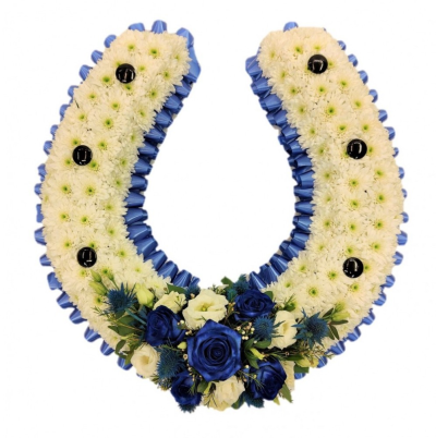 Horseshoe Funeral Tribute - This funeral tribute in the shape of a Horseshoe is available in 2 sizes. 13 33cm and 20 approx 51cm both are fully customisable with colour of ribbon and spray colour. Designed and made by Buttercups & Daisies Florist Birmingham, this Horseshoe offers families a personal way to express remembrance through flowers. The design is assembled patiently, with suitable blooms and foliage positioned to maintain a clear form and balanced character. Flower varieties and foliage depend on seasonal sup...