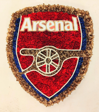 Arsenal Badge funeral tribute - The perfect tribute for the memory of an avid Arsenal football supporter, approx 16W x 18H, 40cm x 46cm This Arsenal Badge funeral tribute is carefully handcrafted in Birmingham for a meaningful farewell, memorial gathering or funeral service. The florists consider proportion, outline, colour balance and texture so the finished design has a dignified, carefully arranged appearance. Because fresh flowers naturally change through the year, particular varieties may be substituted with comparabl...