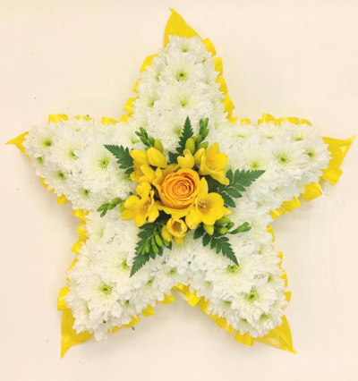 5 pointed star funeral tribute - This star funeral tribute is created here in yellow shades but can be made in different colours. Made on a 13, 32.5cm frame. Handcrafted by Buttercups & Daisies Florist Birmingham, this 5 pointed star funeral tribute is prepared as a thoughtful floral tribute for a funeral, memorial or remembrance service. Shape, scale, contrasting tones and finishing details are assessed closely to create an appropriate and respectful presentation. Seasonal availability can affect individual stems, but the ...