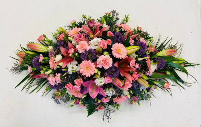 Double Ended funeral spray - This beautiful coffin spray is created using a mixture of cottage garden type flowers in pink whites mauves and purples. Flowers may vary depending on season and availability and every order is created differently. Tribute shown is the Deluxe size. Standard 3ft / 90cm Deluxe 4ft /120cm Luxury 5ft / 150cm Our experienced Birmingham florists create this Double Ended funeral spray with a respectful finish suitable for a funeral, commemoration or celebration of life. Every section is constructed...