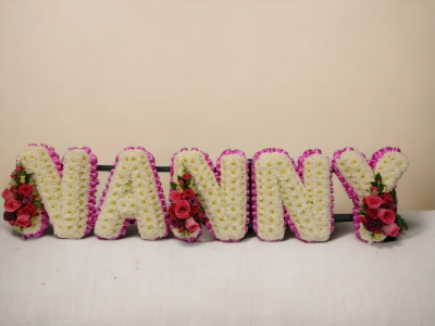 NANNY FUNERAL LETTERING - Honour the cherished memories of your beloved Nanny with our stunning funeral tribute ribbons and colours can be changed to whatever you require. Designed and made by Buttercups & Daisies Florist Birmingham, this NANNY FUNERAL LETTERING offers families a personal way to express remembrance through flowers. The design is assembled patiently, with suitable blooms and foliage positioned to maintain a clear form and balanced character. Flower varieties and foliage depend on seasonal supply; suit...