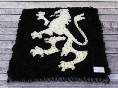 Gatecrasher dragon - Gatecrasher dragon on a 2ft by 2ft designer board This Gatecrasher dragon is carefully handcrafted in Birmingham for a meaningful farewell, memorial gathering or funeral service. The florists consider proportion, outline, colour balance and texture so the finished design has a dignified, carefully arranged appearance. Because fresh flowers naturally change through the year, particular varieties may be substituted with comparable choices that retain the intended palette and shape. Please spea...
