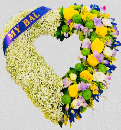 Heart of 2 Halves - A stunning heart-shaped design decorated with delicate gypsophila on one half and a lovely selection of yellow roses, lilac and white freesias, iris and green chrysanthemums on the opposite halftandard 15/ 38cm deluxe 17/ 43cm (as shown) Luxury 21 54cm Designed and made by Buttercups & Daisies Florist Birmingham, this Heart of 2 Halves offers families a personal way to express remembrance through flowers. The design is assembled patiently, with suitable blooms and foliage positioned to maint...