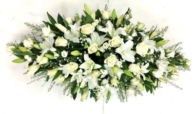 White coffin spray - This white coffin spray is made with a beautiful selection of white flowers, including white roses, lilies, lisianthus, white september flower, thlaspi and foliage. Standard: 3ft. Deluxe: 4ft (as shown). Luxury: 5ft. This item requires at least seven days notice. This White coffin spray is carefully handcrafted in Birmingham for a meaningful farewell, memorial gathering or funeral service. The florists consider proportion, outline, colour balance and texture so the finished design has a dign...