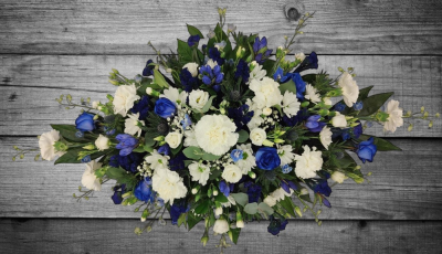 Blue and White coffin spray - This beautiful spray of a selection of flowers in blue and white shades containing, carnations, spray carnations, roses, chrysanthemums, lisianthus, eryngium, delphiniums, gentians and statice with mixed foliage. Standard: 3ft, Deluxe: 4ft (as shown) Luxury: 5ft. Please note, flowers may vary depending on season and availability Handcrafted by Buttercups & Daisies Florist Birmingham, this Blue and White coffin spray is prepared as a thoughtful floral tribute for a funeral, memorial or rememb...