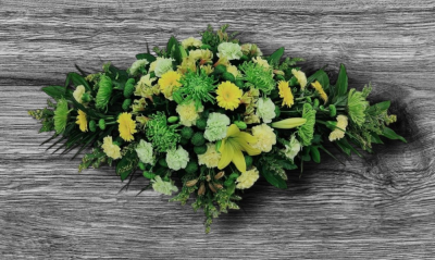 Yellow and Green coffin spray - This beautiful spray of a selection of flowers in green and yellow shades containing, carnations, germini, lilies, chrysanthemums, solidaster, alstroemeria, and mixed foliage. Standard: 3ft, Deluxe: 4ft (as shown) Luxury: 5ft. Please note, flowers may vary depending on season and availability Our experienced Birmingham florists create this Yellow and Green coffin spray with a respectful finish suitable for a funeral, commemoration or celebration of life. Every section is constructed with att...