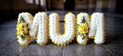 MUM funeral flowers - Mum funeral tribute. A double row of ribbon (colour of choice) massed in white chrysanthemums, with sprays of spray roses and carnations and gypsophillia (colour to match ribbon)all lettering is fully customisable This MUM funeral flowers is carefully handcrafted in Birmingham for a meaningful farewell, memorial gathering or funeral service. The florists consider proportion, outline, colour balance and texture so the finished design has a dignified, carefully arranged appearance. Because fre...
