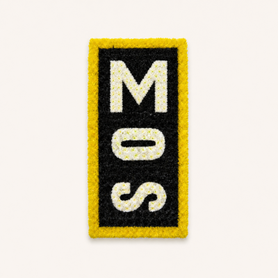 MOS Personalised Lettering Tribute - A distinctive personalised funeral tribute featuring the letters MOS arranged vertically in white flowers against a deep black floral background and finished with a yellow border.