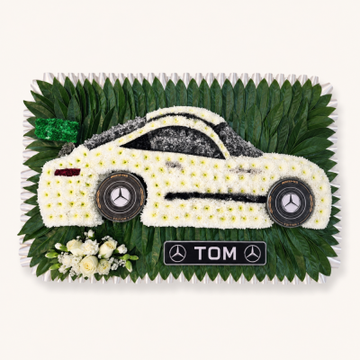 Mercedes Car Funeral Flower Tribute - A highly personal luxury car funeral tribute inspired by a white Mercedes sports car.