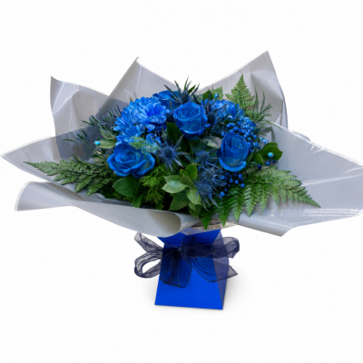 Royal Blue Rose Presentation Bouquet - Royal Blue Rose Presentation Bouquet brings together bold royal blue rose-style flowers, white decorative filler, fresh green foliage and elegant presentation wrapping.
